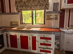 a kitchen with a sink and a window at Soothing home in Brisée Verdière