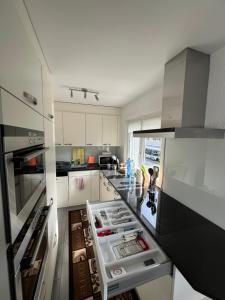 a kitchen with an open refrigerator with its contents at Diamant Apartment in Interlaken