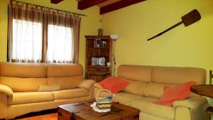 a living room with a couch and a table at Madre Terra in La Puebla de la Sierra