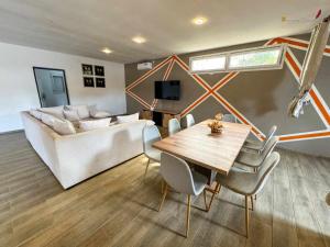 a living room with a table and a couch at Villa Esthera RDC in Antsiranana
