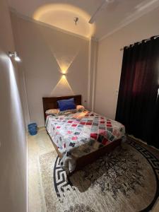 a bedroom with a bed with a quilt on it at Egypt sun accommodation Spiritualities in Luxor