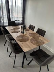 Una mesa de comedor con sillas y una mesa de madera. en Appartement poincaré, en Dijon 2 fotos más