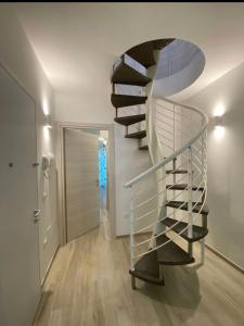 a spiral staircase in a room with a hallway at Casa Vacanze Cimo Marine Style in Civitanova Marche