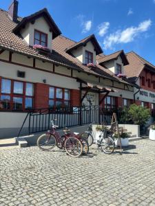 a group of bikes parked in front of a building at Hotel i Restauracja Pod Szyszkami in Krotoszyn