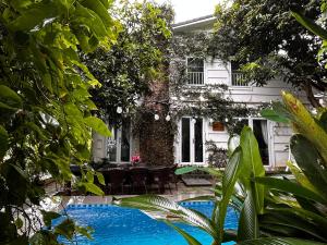a house with a swimming pool in front of a house at Villa La Senlis, biệt thự kiểu Pháp in Hòa Bình
