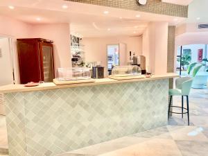 a kitchen with a green and white tiled counter at Kyriad Cannes - Mandelieu in Cannes