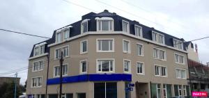 a building with a blue trim on top of it at Ushuaia Suites Connect Point 2 in Ushuaia