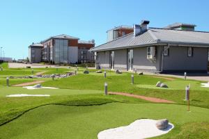 a miniature golf course with a building in the background at Hotel Ambassador Kaluga in Kaluga