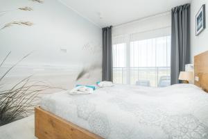 Łóżko lub łóżka w pokoju w obiekcie Westin House Resort Kołobrzeg Apartament 410