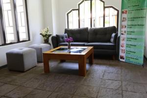 a living room with a couch and a coffee table at Handagedara Resort & Spa in Mirissa