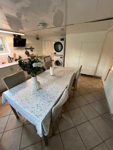 a kitchen with a table with a vase of flowers on it at Casa de Rainer Copenhagen Room 6 in Copenhagen