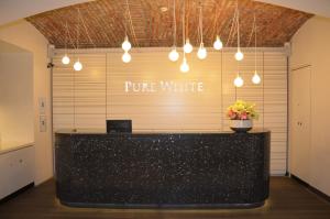 a black counter with a sign that reads pure white at Pure White in Prague