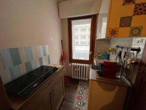 a kitchen with a sink and a stove top oven at Sestriere monolocale in Sestriere +2 photos