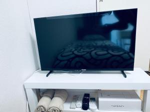 TV a/nebo společenská místnost v ubytování ビアン国立 + 7 fotografií