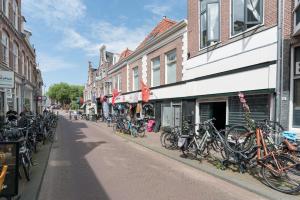 a group of bikes parked on the side of a street at Relaxed Apartments Haarlem in Haarlem