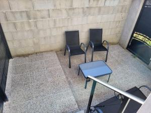 three chairs and a table in front of a wall at Studio La Bâtie-Rolland in La Bâtie-Rolland