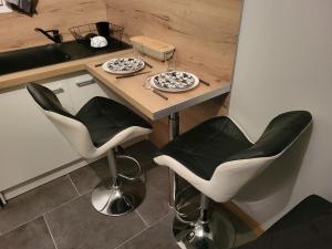 a kitchen with a table with two plates and chairs at Studio La Bâtie-Rolland in La Bâtie-Rolland