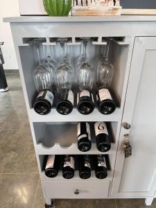 a wine rack filled with wine glasses and wine bottles at Villa La Senlis, biệt thự kiểu Pháp in Hòa Bình