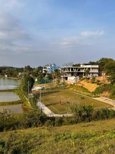 a soccer field next to a body of water at Villa La Senlis, biệt thự kiểu Pháp in Hòa Bình