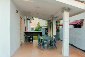 a patio with a table and chairs and a piano at Kundang Villa @ Tasik Biru - 3 Bedrooms Bungalow in Rawang
