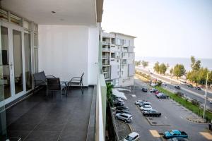 a balcony of a building with a view of a parking lot at Beachfront Luxury Exquisite Retreat above Mall in Maputo