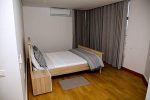 a small bedroom with a bed in a room at Beachfront Luxury Exquisite Retreat above Mall in Maputo