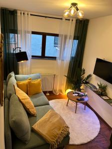 a living room with a couch and a table at La Nano Maison de Liège in Liège