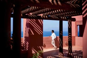 a man walking on the roof of a building at The Ritz-Carlton Tenerife, Abama in Guía de Isora
