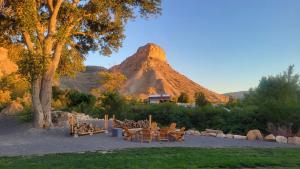 a group of tables and chairs in front of a mountain at The Homestead in Palisade