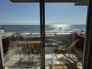 a balcony with chairs and a view of the ocean at Azur à la Chaume in Les Sables-dʼOlonne