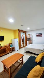 a large bedroom with a bed and a table at Encantador Estudio con Terraza Privada y Espectaculares Vistas al Mar en Costa del Silencio, Cerca de Los Cristianos in Costa Del Silencio