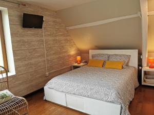 a bedroom with a bed and a tv on a wall at La Coticia en Pévèle in Coutiches +40 photos