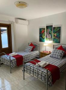 a bedroom with two beds and a table with a lamp at Casa Terria in Tías