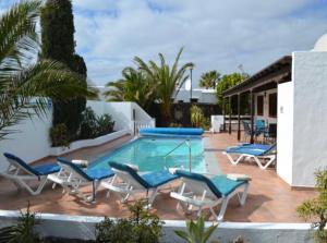 a swimming pool with lounge chairs and a swimming pool at Casa Terria in Tías +7 photos