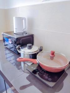 a kitchen counter with a pan on top of a stove at Spacious Family House at Desaru Harmonia 2 in Desaru