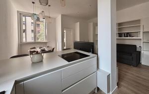 a kitchen with a counter and a living room at Studio8 in Bollate