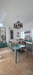 a kitchen with a table and chairs in a room at Dar Inès in Tangier
