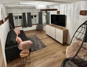 a living room with a couch and a flat screen tv at Dornröschen in Dinkelsbühl