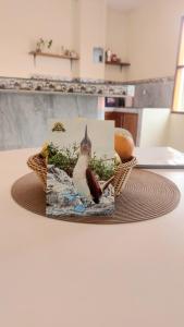 a picture of a bird in a basket on a table at Casa Playa Los Marinos in Puerto Baquerizo Moreno