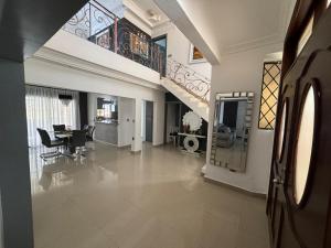 a living room with a staircase and a dining room at Casa familiar con piscina y cerca de la playa in La Belleza