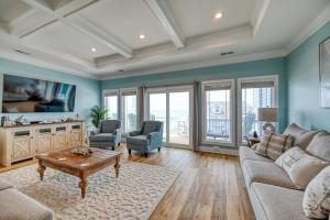 een woonkamer met een bank en een tafel bij Unobstructed Ocean Views - Hot Tub - Sandy Path to Beach in North Topsail Beach