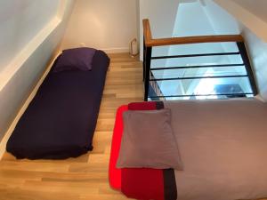 a room with two beds and a stair case at Abri du pêcheur in Étel +17 photos