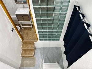 a bathroom with a staircase with a sink and a sink at Megun 10 Duplex in Bangkok