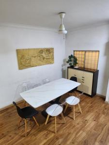a white table and chairs in a room at Jacuzzi POOL 3Bedroom, walk to Stadium in Kuala Lumpur