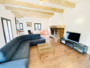 a living room with a blue couch and a fireplace at La Villa Lou Castel in Sanary-sur-Mer