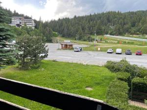 a parking lot with cars parked in a parking lot at Studio au pied des pistes in Bolquere Pyrenees 2000 +17 photos