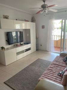 a living room with a couch and a flat screen tv at Lovely 2 bedroom apartment on El Divino, Los Alcazares in Los Alcázares