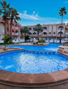 a large swimming pool in front of a resort at Lovely 2 bedroom apartment on El Divino, Los Alcazares in Los Alcázares