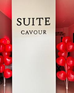 a bunch of red balloons in a room with a sign at Luxury apartment - SUITE CAVOUR in Bari +20 photos