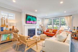 a living room with a couch and a fireplace at Sleek Long Branch Vacation Rental with Pool and Patio! in Long Branch